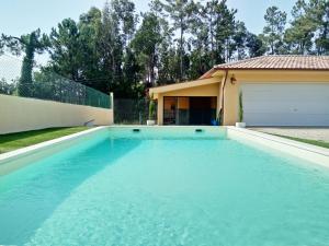 a swimming pool in front of a house at Casa de Barreiros Studio AP in Barreiros