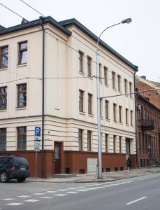 a building on the corner of a city street at Brother House Kaunas in Kaunas
