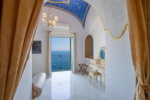 a hallway with a room with a view of the ocean at Palazzo Rocco Villa Sunshining in Love in Praiano