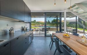 a kitchen with a wooden table and a dining room at Luxury villa Fratello in Istria, private pool in Barban