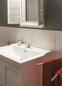 a bathroom with a white sink and a mirror at Cosy Authentic Farmhouse - LaComte5 in Vielsalm