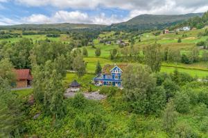 an aerial view of a blue house in a field at Modern Apartment with panorama wiew in Blakset