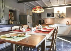 a kitchen with a large wooden table with chairs at Cosy Authentic Farmhouse - LaComte5 in Vielsalm