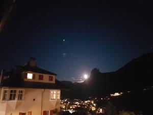 a view of a mountain at night with the moon at Hotel Villa Emilia in Ortisei