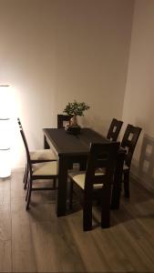 a dining room table and chairs with a plant on it at Modern apartment fully equipped in Amsterdam