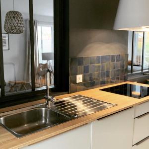 a kitchen with a sink and a counter top at La Maison de l’Ocean - plage à 75 mètres in Saint-Martin-de-Ré