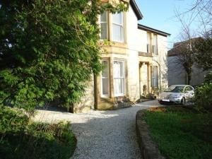 a white car parked in front of a house at Bishopton Apartment, near Glasgow in Bishopton