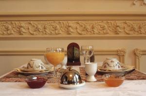 a table with plates and wine glasses on it at Atlas B&B in Ghent