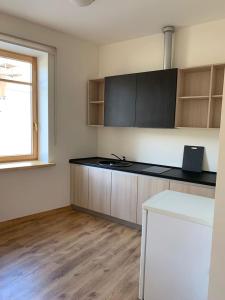 a kitchen with a black counter top and a window at Сhocolate Factory Apartment Nr.2 in Riga