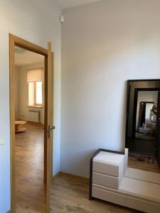 a room with a door and a mirror and a drawer at Сhocolate Factory Apartment Nr.2 in Riga