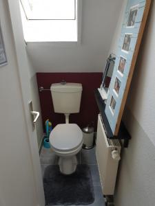 a small bathroom with a toilet in a stair case at Ferienwohnung im Grünen in Gschwend +12 photos