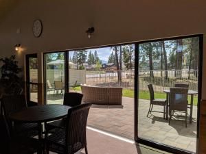 a room with a patio with a table and chairs at GrandStay Hotel & Suites in Sisters
