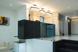 uma cozinha com armários pretos e escadas num quarto em MC Suites Mexico City em Cidade do México