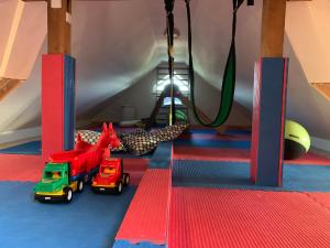 a childs room with two toy trucks on the floor at Vila na Skalce in Česká Kamenice