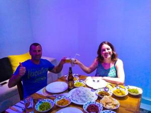 a man and woman sitting at a table with food at Miheen Hotel & Resort - Anuradhapura in Mihintale