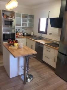 a kitchen with a wooden counter top in a kitchen at Heavens Garden House in Playa del Ingles