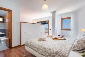 una camera da letto bianca con un letto e un bagno di 2 CHARMING VILLA Private Pool and Sea View ad Adeje Altre 43 foto