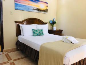 A bed or beds in a room at Arecibo Inn