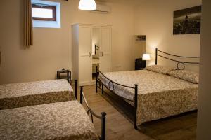 a bedroom with two beds and a window at Casa Concerie Quattro in Sulmona