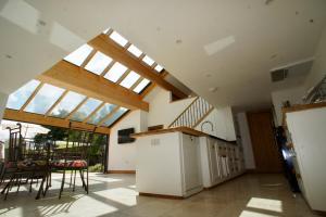 an open kitchen and dining room with a skylight at Southrepps BarnHam in Cromer
