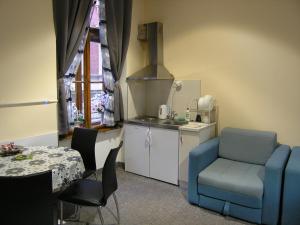 a kitchen with a blue chair and a table at Apartment Danijela-City Centar in Belgrade