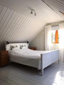 a bedroom with a white bed and a window at Villa Verde in Kihelkonna