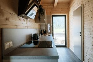 a kitchen in a tiny house with a counter top at Clofers Relax Residences Rattendorf in Rattendorf