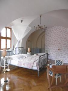 a bedroom with a large bed and a table at Suite Hans in Bautzen