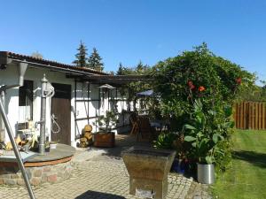a garden with a patio with a bush at Pension Fennert in Pritzwald