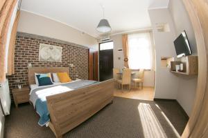 a bedroom with a bed and a brick wall at Willa Idylla in Ustka