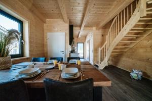 a wooden dining room with a table and chairs at Clofers Relax Residences Rattendorf in Rattendorf