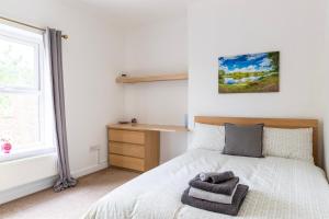 a bedroom with a bed and a window at SunnyBank in Denby Dale