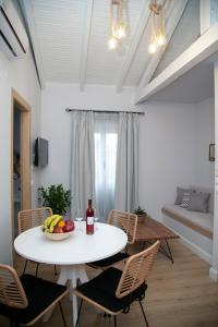 un comedor blanco con una mesa y sillas blancas en Foxnest Rest Villa Corfu, en Kanálion