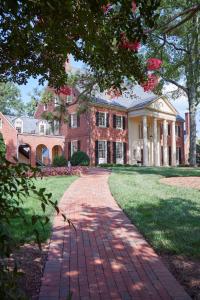 a brick driveway leading to a large house at Rizzo Center, a Destination by Hyatt Hotel in Chapel Hill
