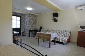 a living room with a couch and a table at To Asteri in Avgonyma