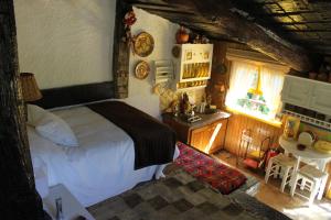 a bedroom with a bed and a kitchen with a sink at Casas Da Azenha in Vila Nova de Cerveira +108 photos