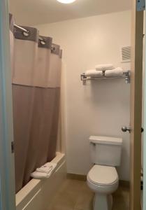 a bathroom with a toilet and a shower with towels at Motel 6-Yakima, WA - Downtown in Yakima