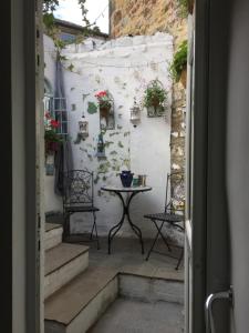 a room with stairs and a table with plants at Little Pinfold Cottage in Skipton +23 photos