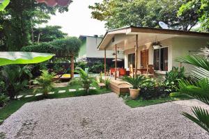 a small house with a patio with plants at Villa Picasso in Santa Teresa Beach