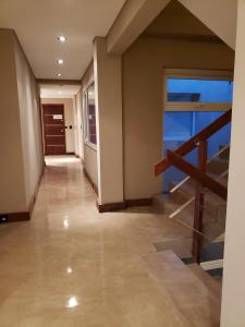 a hallway of a house with a staircase and a window at URBANA APARTMENTS 413 in San Carlos de Bariloche