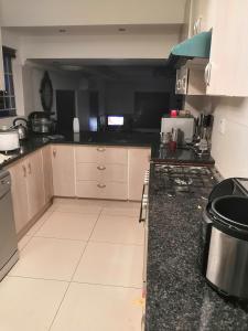 a kitchen with a stove and a counter top at LEONE PARIS in Windhoek