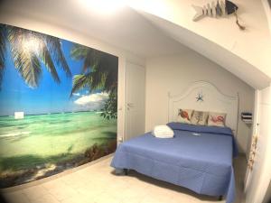 a bedroom with a painting of a beach at Villa Acquamarina semi detached villa with private pool and wifi in Torre delle Stelle +26 photos
