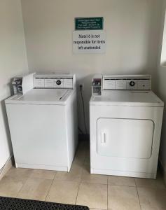 zwei Waschmaschinen und ein Schild an der Wand in der Unterkunft Motel 6-Yakima, WA - Downtown in Yakima