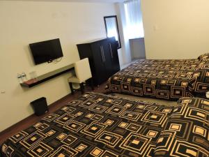 Postel nebo postele na pokoji v ubytování Hotel Granada