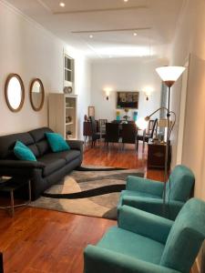uma sala de estar com um sofá e uma mesa em Grandmommy's House - Traditional and comfy Lisboan apartment em Lisboa