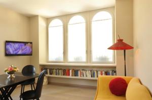 a living room with a yellow couch and a table at Sopra Il Posta in SantʼOmobono Imagna