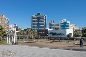 a park in a city with tall buildings at Hotel Bastit in Mar del Plata
