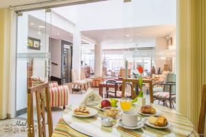 a table with breakfast food on it in a room at Hotel Bastit in Mar del Plata