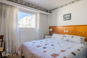a bedroom with a large bed and a window at Hotel Bastit in Mar del Plata +62 photos