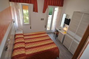 Postel nebo postele na pokoji v ubytování Hotel Righetto Fronte Mare